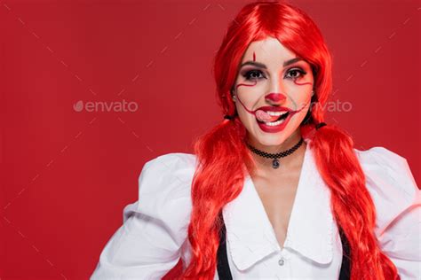 Cheerful Woman With Bright Long Hair And Clown Makeup Sticking Out