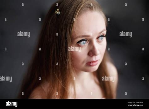 close up portrait of natural beautiful thoughtful woman with gray eyes looking away wearing
