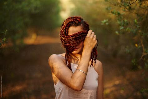 Woman Covering Face With Braids In Nature Del Colaborador De Stocksy Guille Faingold Stocksy