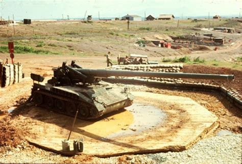An Old Tank Sitting On Top Of A Dirt Field