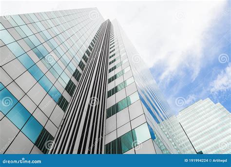Modern Business Office Building With Glass Windows Reflect The Skyline