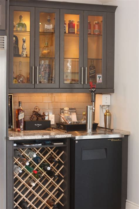 Wine cooler (wine cellar / wine chiller) a must have: Custom wine rack in bar area with Kegerator and glass door ...
