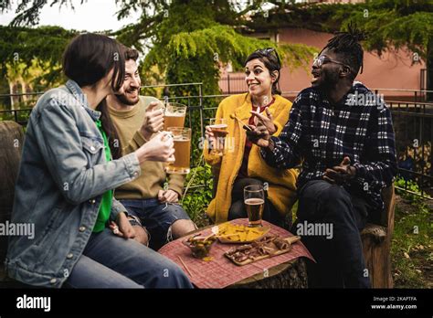 Group Of Multiethnic Young People Drinking Beers In The Terrace Patio