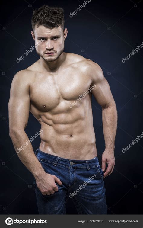 Young Strong Man On Dark Background Stock Photo By ©camaralenta 188619918