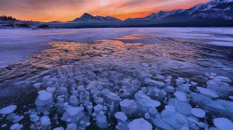 Download Wallpaper 1600x900 Lake Ice Snow Winter Sunset Horizon Widescreen 169 Hd Background
