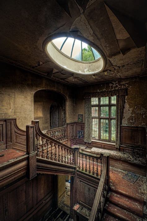 An Abandoned House With Stairs And Windows