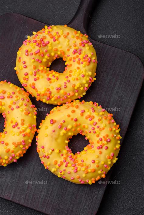 Delicious Fresh Donuts In Yellow Glaze With Lemon Flavor Filling Stock