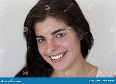 Closeup Of Smiling Beautiful Young Brunette Girl With Piercing Green