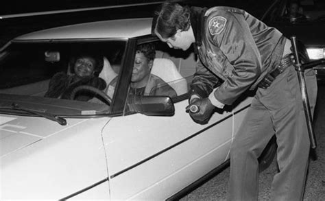 los angeles county sheriff s deputy talking to a motorist at a field sobriety checkpoint los