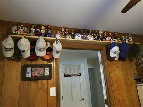 Hanging hats from a Bobblehead display shelf above the office door ...