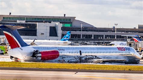 Plane crashes into tower and bursts into flames at Miami Airport after
