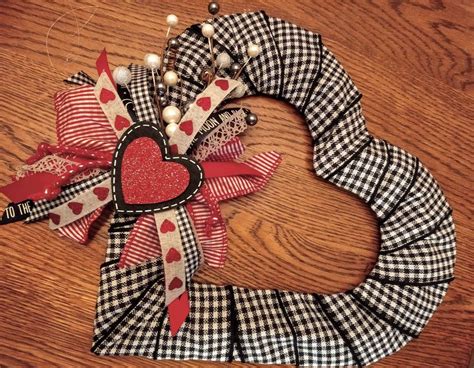 A Valentines Day Wreath Made Out Of Fabric And Ribbon