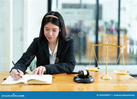 Portrait Of A Beautiful Asian Lawyer Studying A Lawsuit For A Client
