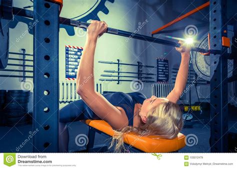 Fit Young Woman Lifting Barbells Looking Focused Working Out In A Gym Stock Image Image Of