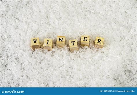 The Word Winter Made Of Letters On Wooden Cubes On A Snow Background 3