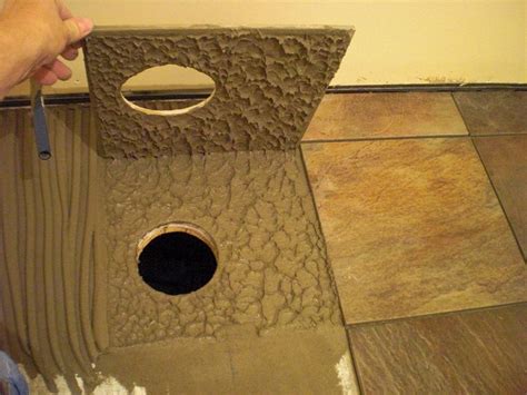 I am placing 12x12 ceramic mat tiles on the ceiling and surround of my bath tub. Using the proper trowel