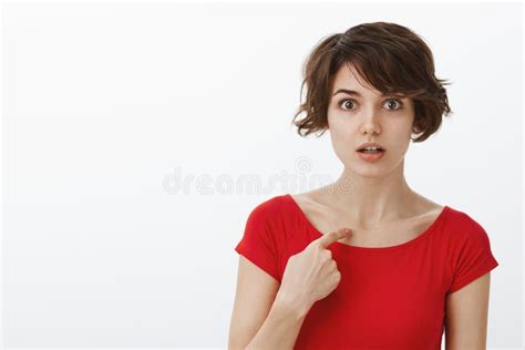 shocked stunned intense european woman short haircut pointing herself index finger indicated