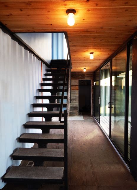 Side view on industrial modern flight of stairs with a turn without rails. Modern Shipping Container Cabin - Industrial - Staircase - denver - by Tomecek Studio Architecture