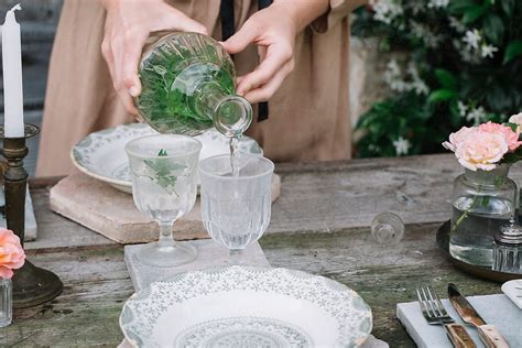 Woman Pouring Drink In Glasses Del Colaborador De Stocksy Studio Serra Stocksy