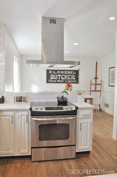 The kitchen island has become the core of this part of the house. Square, modern island range hood by Summit on DESIGN ...