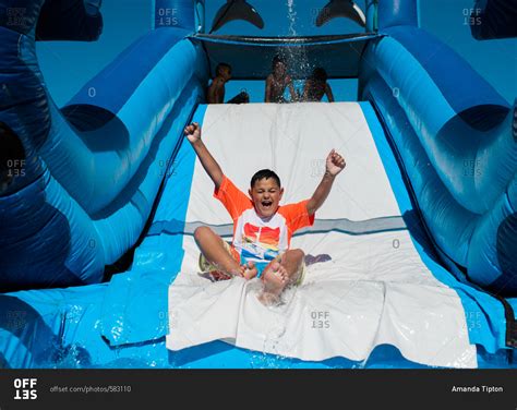 Excited Boy Going Down Water Slide Stock Photo Offset