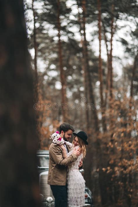 Romantic Fairytale Wedding Couple Kissing And Embracing In Pine Forest