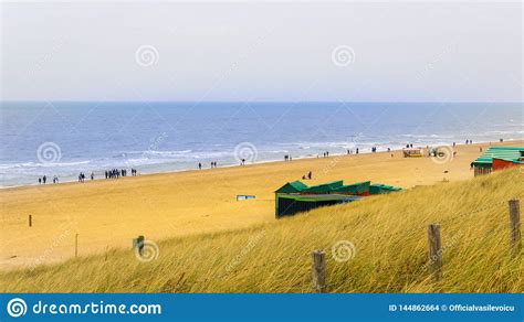 A View Of The North Sea Beach Autumn With Blue Water And Yellow Grass