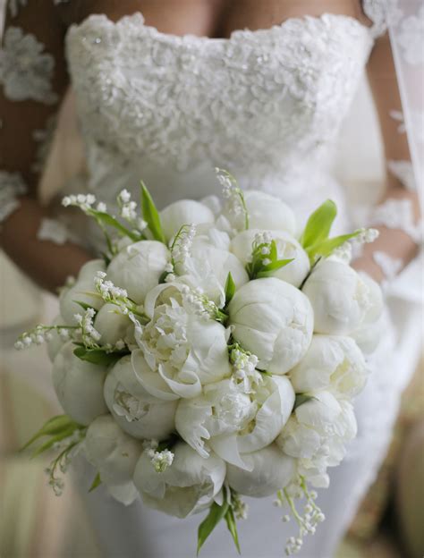 stunning bridal bouquet showcasing white peonies white lily of the valley and green foliage lily