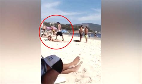 Video Captures Sunbathing Girl Getting Huge Shock When Beachgoer Does