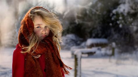 Blonde Little Cute Girl Is Wearing Red Dress And Head Covered With Muffler In Snow Forest ...