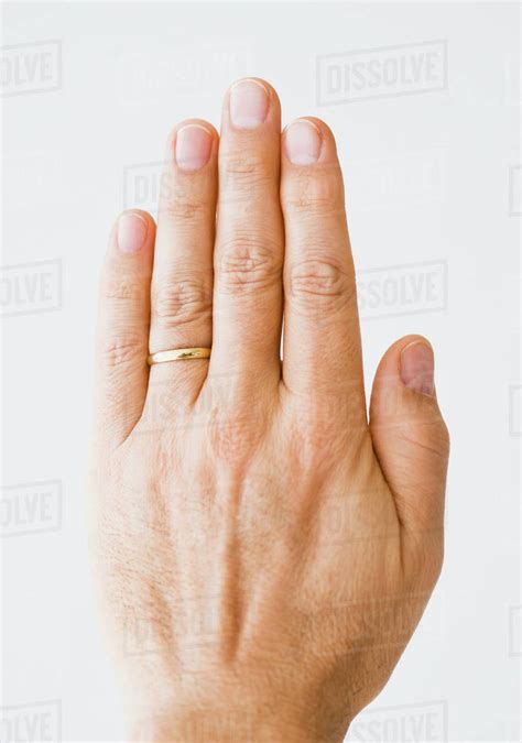 Close Up Of Mans Hand Wearing Wedding Ring Stock Photo Dissolve