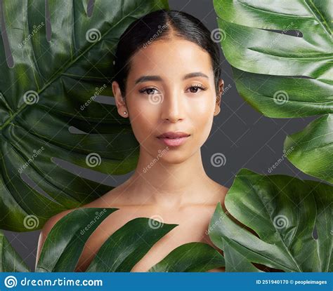 Studio Portrait Of A Beautiful Mixed Race Woman Posing With A Leaf