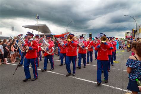 A Brass Band In Red Uniforms Marching Down The Street Editorial Image