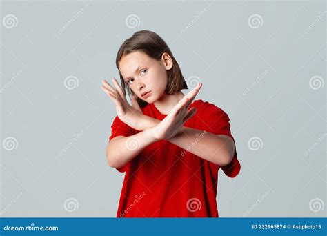 Serious Brunette Teen Girl Shows Cross Stop Gesture Looking Unamused