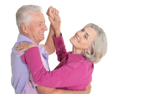 premium photo happy senior couple dancing on white background