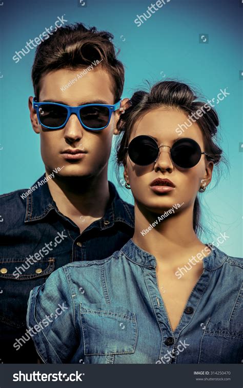 Portrait Of A Modern Young People Wearing Jeans Clothes And Sunglasses