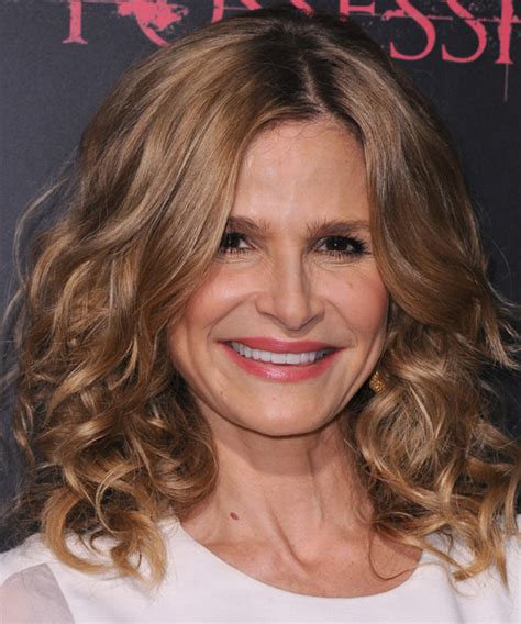 Kyra Sedgwick Medium Curly Formal Hairstyle Light Caramel Brunette Hair Color With Blonde