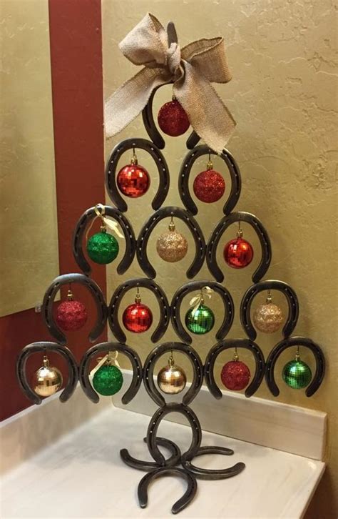 Glue one horseshoe sticking up on top of another horseshoe and hang on the wall. Horseshoe Christmas tree ideas - DIY Christmas tree craft projects