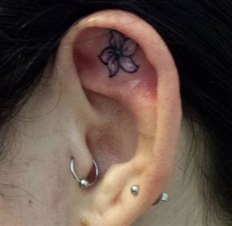 Flower Ear Tattoo Would Look Cute With The Diamond Piercing In The Middle Ear Tattoo