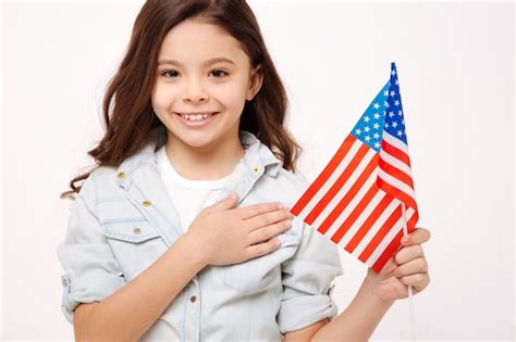 Premium Photo Joyful Charming Cute Girl Holding The American Flag