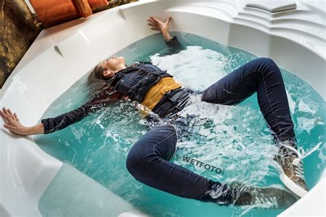 Hot Girl Puts On Tights Under The Jeans And Lays Down In A Denim Outfit In The Water Wetfoto Com