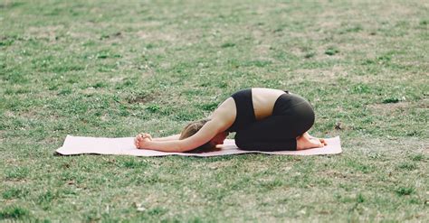 Relaxed Barefoot Woman Performing Yoga Exercise On Green Field · Free