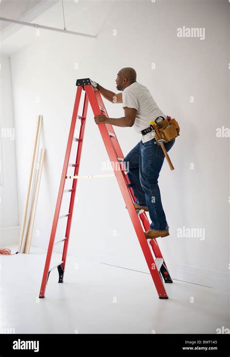 African American Construction Worker Climbing Ladder Stock Photo Alamy
