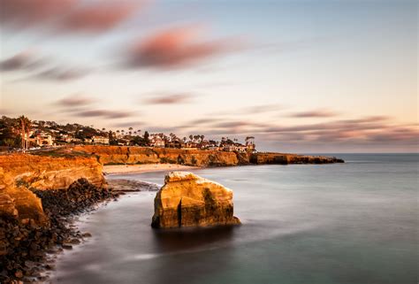Brown cliff near ocean water under gray clouds, san diego HD wallpaper