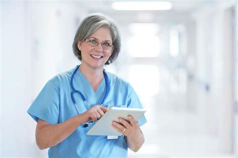 Mature Female Doctor Using Tablet Photograph By Science Photo Library Fine Art America