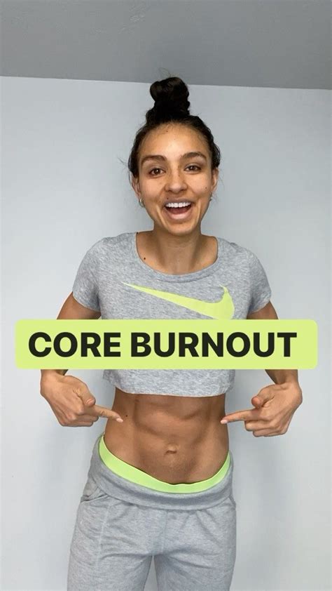 A Woman Holding Up A Sign That Says Core Burnout On It S Chest