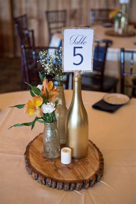 wedding reception centrepiece  wood   gold wine bottle