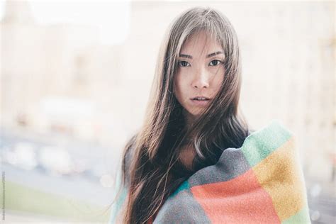 Beautiful Woman Wrapped In Colored Blanket Looking At Camera Horizontal By Stocksy Contributor