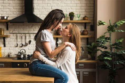 Free Photo Romantic Young Lesbian Couple Loving Each Other In Front Of Window With White Curtain