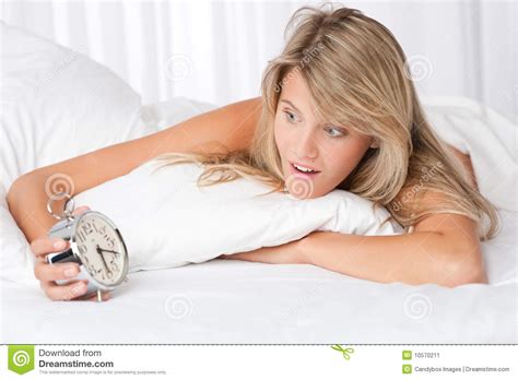 Young Woman Surprised Holding Alarm Clock Stock Image Image Of White Pillow 10570211